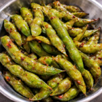 Garlic edamame tossed in butter, garlic, and soy sauce, served warm as a Japanese-inspired appetizer.