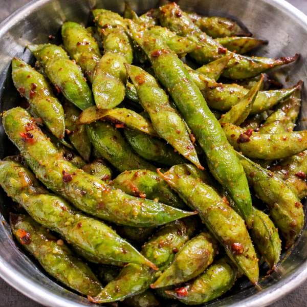 Garlic edamame tossed in butter, garlic, and soy sauce, served warm as a Japanese-inspired appetizer.