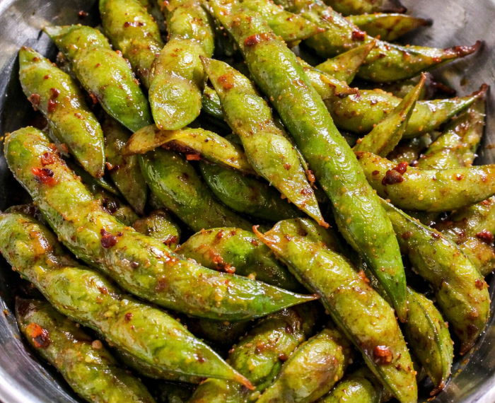 Garlic edamame tossed in butter, garlic, and soy sauce, served warm as a Japanese-inspired appetizer.