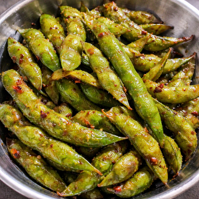 Garlic edamame tossed in butter, garlic, and soy sauce, served warm as a Japanese-inspired appetizer.